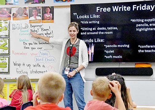 Aurora first grade teacher Sara Luzum begins her Free Write Friday session encouraging her students to write about a subject that comes from their heart.