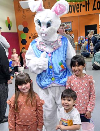 From left, Ayven Rodrigrieuz, Fenix and Miah Barajas pose for a picture with the Easter Bunny.