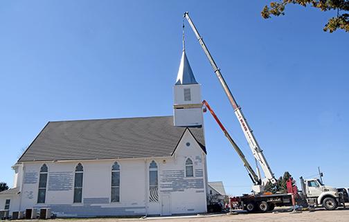 A crane lifts Immanuel Lutheran Church's new steeple atop the new bell tower on March 19.