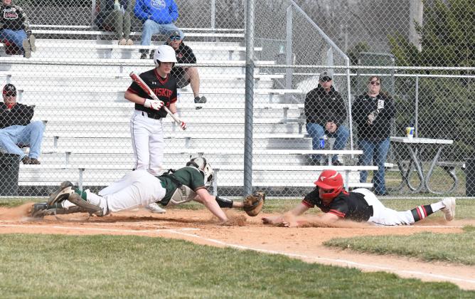 Jace Dorsey goes full extension at the plate in what became a loud collision during Aurora’s 18-7 win over Maxwell St. Pats Friday. 