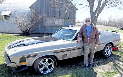 Glenn Nielsen stands next to his 1971 Mustang that took six years for him and his friends to fully restore.