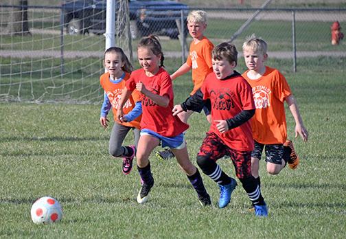 Soccer players in Aurora's Optimist Youth Soccer league dash after the ball on Saturday morning. 