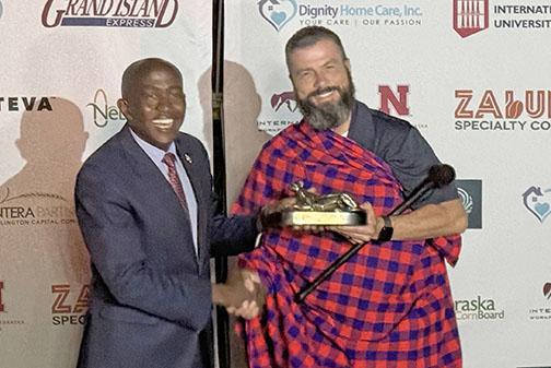 On his trade mission trip to Kenya in February, Giltner farmer Brandon Hunnicutt (right) receives gifts from Dr Gideon Maina, Vice Chancellor of Pioneer International University. The school was founded by the man who was the first Pioneer Seed dealer in Kenya and is known as the “Warren Buffett of Kenya.” 