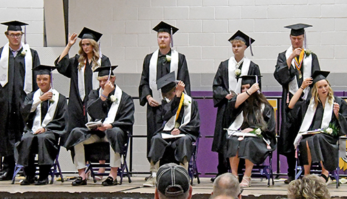 Hampton graduating seniors turn the tassels on their caps after receiving their diplomas on May 9. 