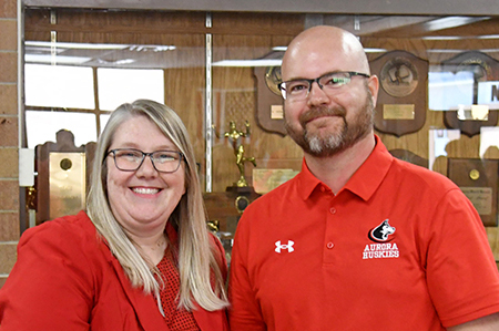 Nebraska School Counselor Association Executive Director Malinda Jean Baptiste congratulates Aurora High School Counselor Jacob Willems after naming him as the Nebraska School Counselor of the Year for 2026.  