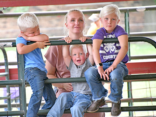 There’s something for everyone at the Hamilton County Fair as future animal showmen hang out and catch a glimpse of Thursday’s sheep show. Pictured with their mother, Laura Oswald, are three of her children, from left: McCoy, Merit and Emmie Oswald.