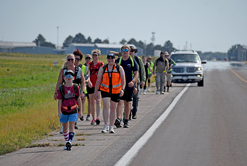 Area residents set out on a march from Aurora to Marquette Friday to commemorate the 25th anniversary of the 9/11 attacks