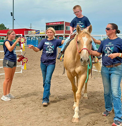 Brooks Borrell was one of the 29 riders who participated in the first Adaptive Horse Show at the State Fair. He is shown here riding the horse, Peaches. Pictured with Borrell, from left, are Bria Schaeffer, Anna Hanquist and Cortney Brades.