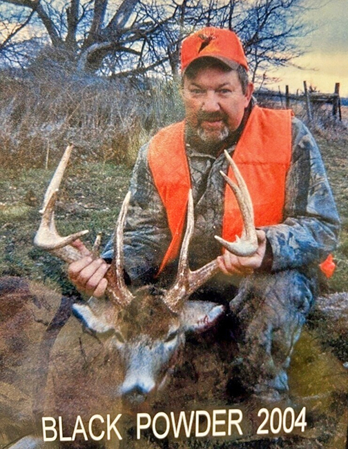 Deryl Hilligas poses with buck he took down on the last day of black powder season in 2004. The deer has unusually long brow tines measuring 11 inches. 