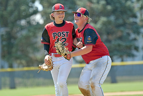 Knox Suchanek (left) and Tate Bendorf celebrate after Aurora’s 7-2 victory over Wayne in Saturday’s state tournament opener. 