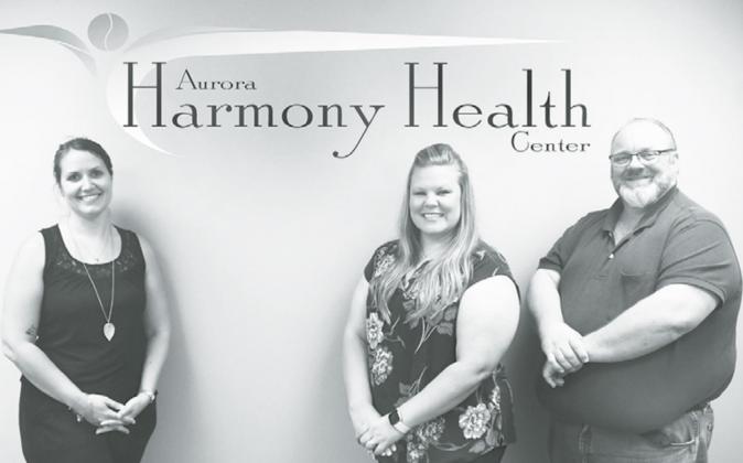 Aurora native Vicki Hill, center, is pictured with Aurora Harmony Health Center co-owners Rhiannon Woodruff and Brad Shay, who have 11 and 29 years of counseling experience, respectively. The new clinic opened in Aurora Aug. 19. News-Register illustration