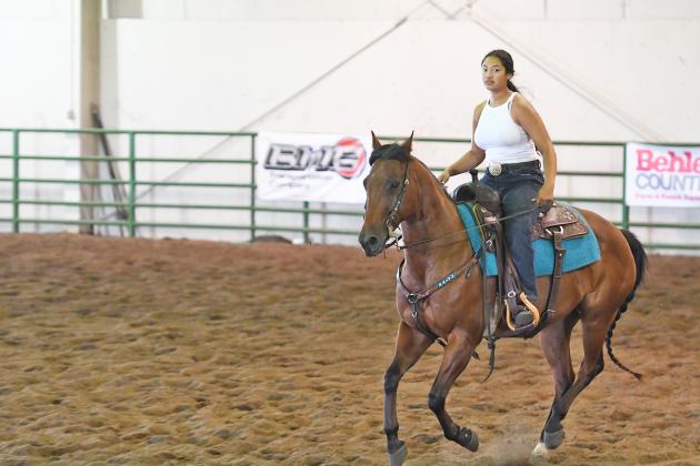 Jamie Nissen warms up with her horse Beau before a competition at the Nebraska State Fair.