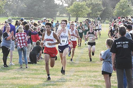 Alexander Wheeler (left) keeps the pace as he heads toward the finish line while teammate Quinten Smith (third from left) gives a final push to gain ground.