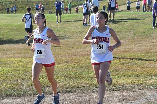 Kaitlyn Oswald (left) and Natalie Bisbee set their pace at the beginning of the Seward Invite. News-Register/Jeni Moellenberndt