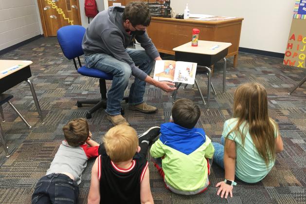 Hunter Gress reads a story to kindergarteners as part of the community service portion of senior seminar.