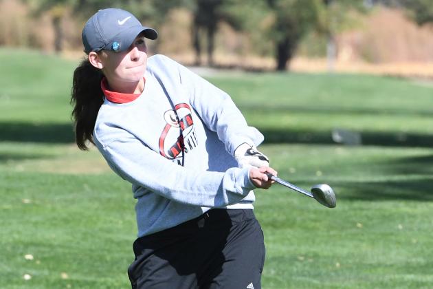 Emma Young eyes her chip on to the first green at Holdrege Friday during conference competition.