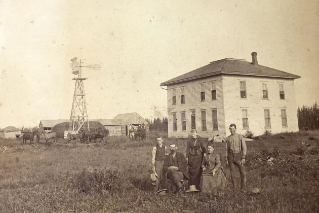 The caption below this original photo reads ‘A.J. McConaughey and family first custodian of the Hamilton County Poor Farm, Section 22, Orville Precinct 1884-1892.’ Those pictured are, from left: B. E. McConaughey, A. J. McConaughey, May (Mrs. May Fowler) McConaughey, Mrs. A. J. (Drussila) McConaughey and Ora T. McConaughey. Mr. James Bird is in the wagon on the left.