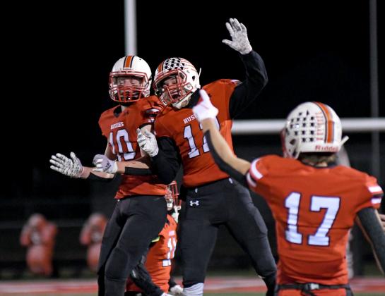 Cayden Phillips (10) and Andrew Bell celebrate as the final seconds tick off in Aurora's 21-12 win over Plattsmouth in the Class B semifinals.