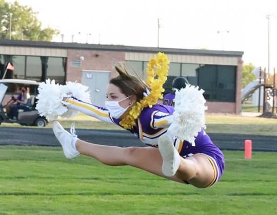 Hampton senior cheerleader Lexie Wolinski shows her form during a Hawk football game this fall.