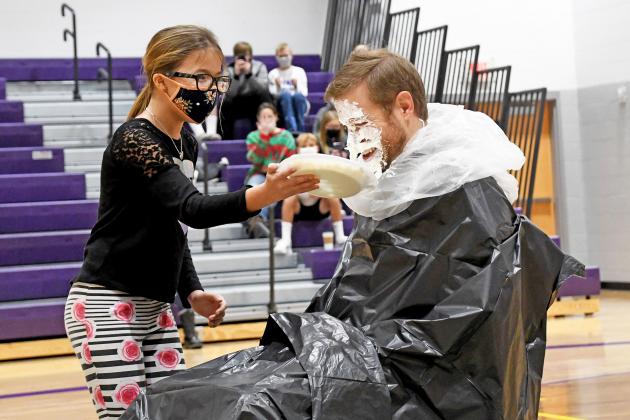 Kiney Russell-Lutt had the honor of throwing the first pie at high school principal and activities director Brad Feik.