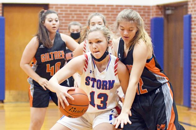 HPC’s Brianna Wilshusen fights through heavy traffic that included Giltner’s Alice Wiles during the Lady Storm’s 47-18 win Friday night. Wilshusen led the way with 16 points. 
