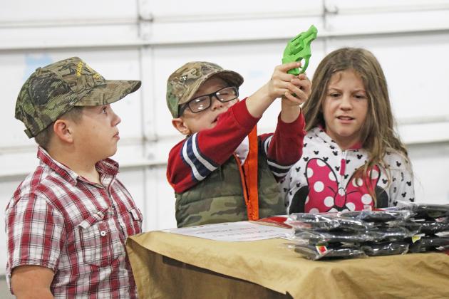 Sighting in this plastic gun with expert precision were Trent Vap (left), Bentley Vap and VaNessa Vap, who were very excited about the various vendors during day one of the inaugural Craft, Toy and Gun Show at the fairgrounds.