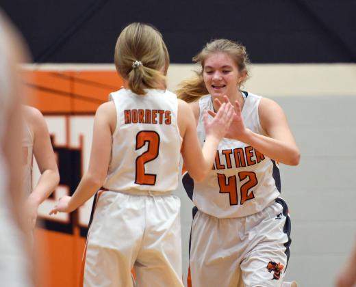 Giltner's Alice Wiles (42) celebrates with Hailey Eastman after the Lady Hornets picked up its first win of the season. 
