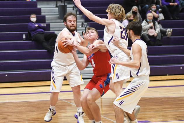 HPC’s Lane Urkoski finds himself in heavy Hawk traffic during the Storm’s 46-37 win at Hampton Thursday. 