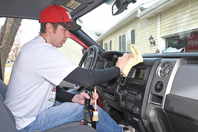 Tyler Nunnenkamp polishes the inside of a vehicle as part of his new business, Nunnenkamp Auto Detailing. He started his  home-based Aurora business in November and said he has been pleased with the initial response.
