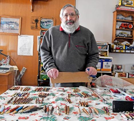 Steven Robotham of Marquette stands proudly with his current selection of hand-crafted pens that consist of plastic, wood and antler.