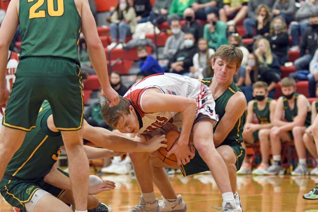 Aurora’s Cayden Phillips fights to retain possession with defenders coming from all angles during the Huskies’ 58-34 loss at home Thursday. 