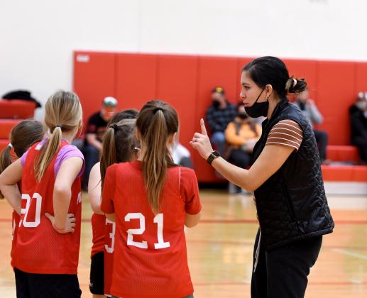Coach Chelsea Arendt works with the Aurora Husky Pups 4th grade team during a timeout Saturday morning at the PAC.