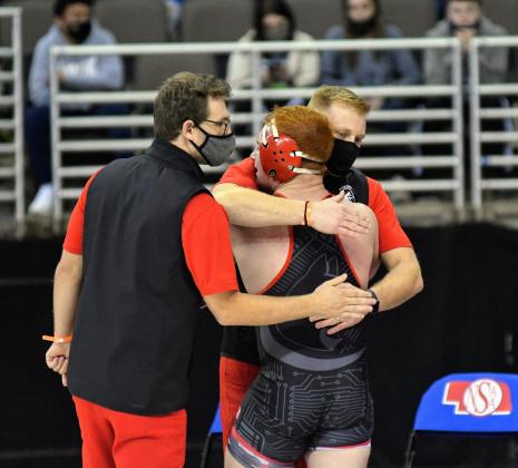 Brekyn Papineau embraces coaches Derek Keasling and Brandon Timm after finishing 3rd at 195.