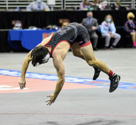 Trevor Kluck celebrates with a backflip after winning his first state championship.