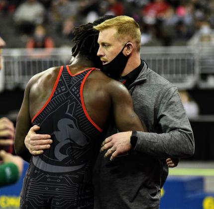 Mack Owens and Aurora coach Derek Keasling embrace after Owens' finals loss Saturday night. 