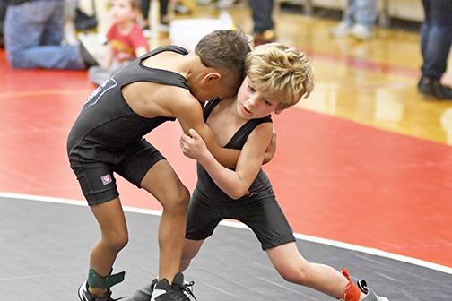 Aurora’s Kannon DIllon and Leo Johnson battle it out during competition at Friday’s youth wrestling tournament. 