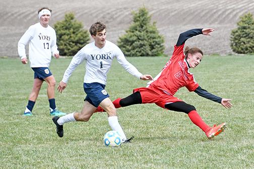 Aurora’s Kyler Gross receives heavy contact from York’s Emmet Heiss during the Duke’s 2-0 win over the Huskies Saturday.