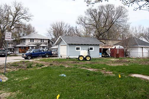 The buildings and house in the background are 14th Street lots rezoned last week by the Aurora City Council. The Aurora Cooperative has announced preliminary plans to expand operations from across the street, where the service center is now located.