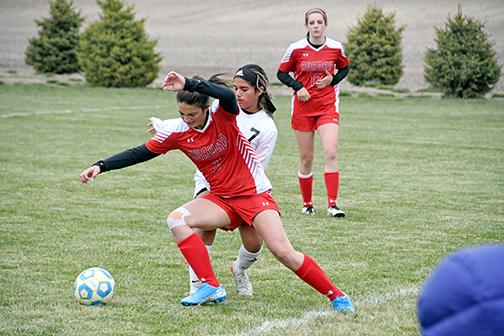 Aurora’s Zayden Roberts battles for possession in the second half of Aurora’s 3-1 overtime loss to Lexington Thursday. 