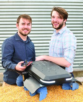Ben Johnson, left, and Zane Zents show the latest model of the Grain Weevil, which earned them a prestigious MIT prize.