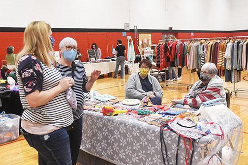 Susan Gray, pictured at right, can be seen chatting and selling her bags to customers at a craft show last year.