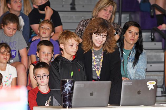 Hampton elementary teacher Margo LaBrie and one of her students, Bentley Hagan, visit via computer with NTV’s Kent Boughton during Friday’s Outstanding Teacher presentation as part of the end-of-the-year Hawk Honors assembly. Hagan nominated LaBrie for the award.