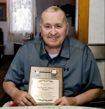 Marv Rogers holds the plaque given to him by the village of Hordville in honor of his years of service to the community.