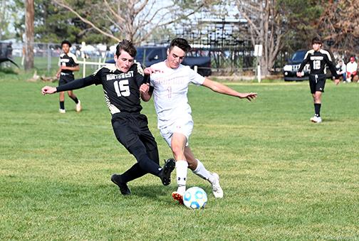 Aurora senior Jameson Herzberg battles for position with a Northwest defender during B7 District play in Grand Island. The Vikings won the game, 3-0.