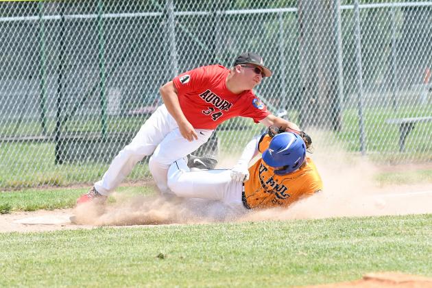Aurora’s Jayden Quandt takes heavy contact in a play at third during the Aurora Cooperative Juniors’ loss Sunday. 