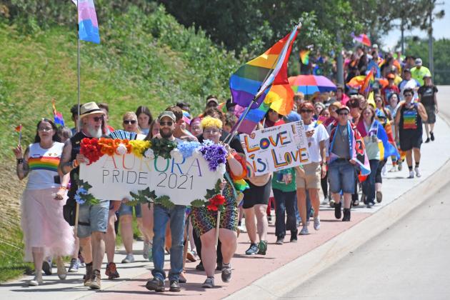 More than 125 people paraded down Highway 14 Sunday during Aurora’s first-ever Pride March.
