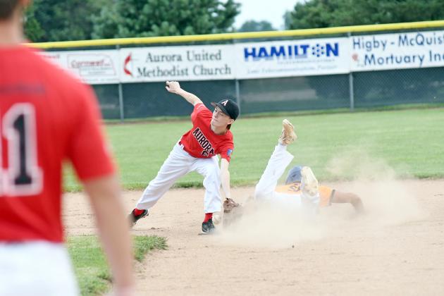 Max Wiarda tries to get the tag down on a St. Paul baserunner during Aurora’s 13-6 loss at home Sunday. 