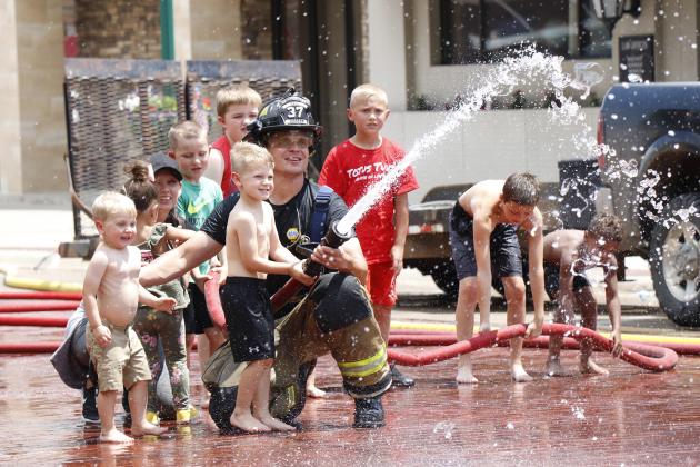A fan-favorite of A’ROR’N Days, the Aurora Fire Department’s water fight welcomed children big and small to have a little summertime fun. Pictured here, AVFD member Derek Dibbern helps Briggs Beins aim the fire hose.