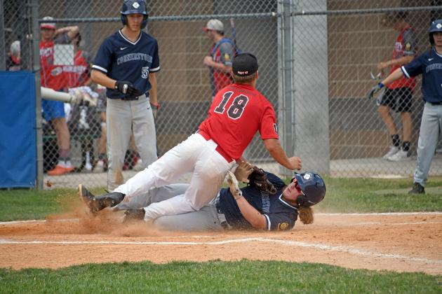 Aurora’s Garrett Bellis attempts to cover home on a play at the plate during an 11-3 loss to York Monday in the Class B, Area 4 tournament.