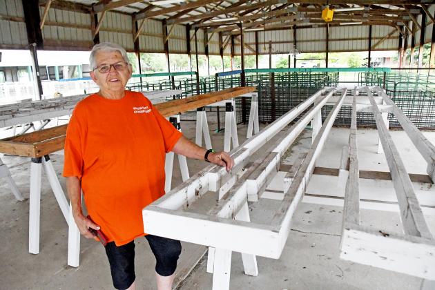 As superintendent, Marcia Traudt has made a point to have a hand in many aspects of her animals. Here she stands next to the table tops she and her husband built to hold poultry and rabbit cages.